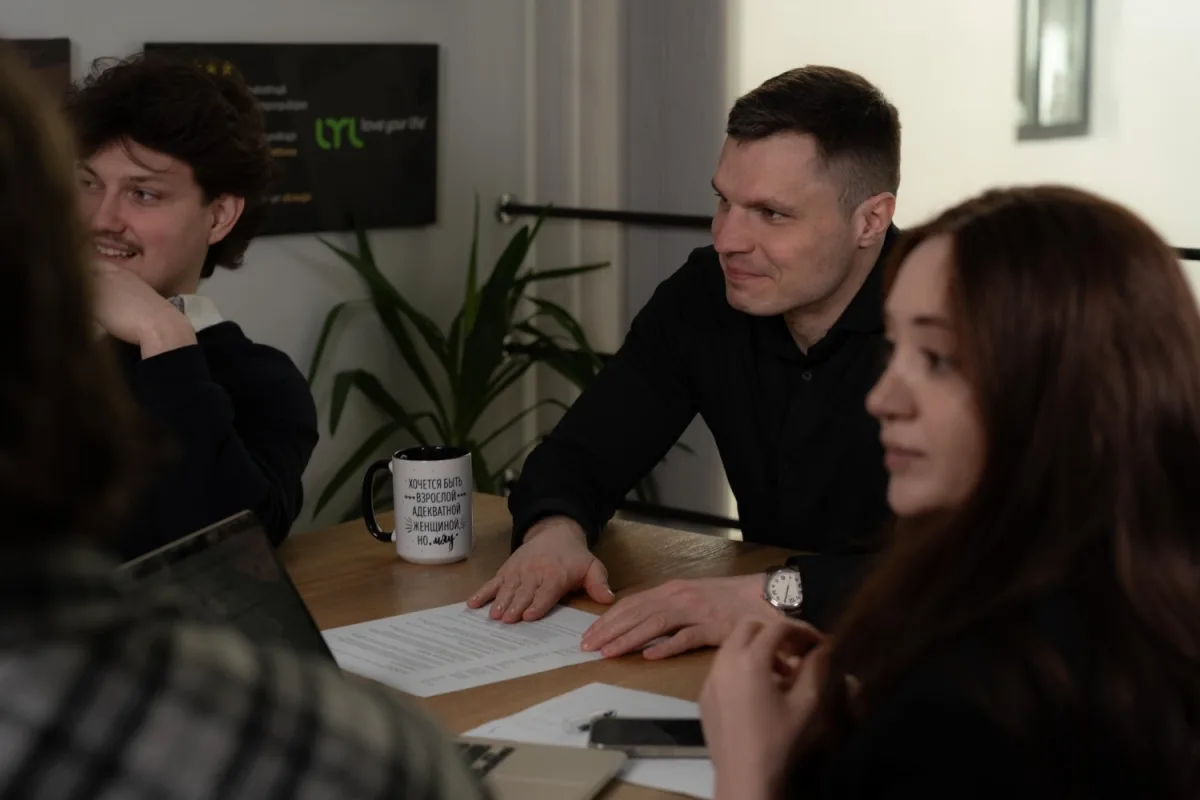 eCommerce store owner discussing store performance with colleagues around a meeting table
